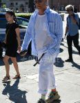 A men's spring/summer/fall outfit for men with plain gold sunglasses, light blue striped shirt, plain white t-shirt, plain black tape belt, plain white cargo pants, white/gray striped socks, and Balenciaga beige low-cut sneakers.