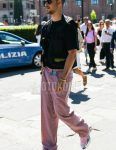 A summer men's outfit of plain black sunglasses, plain black t-shirt, plain gilet, plain pink tape belt, plain pink cotton pants, and Raf Simons Adidas Oswego pink/silver low-cut sneakers.