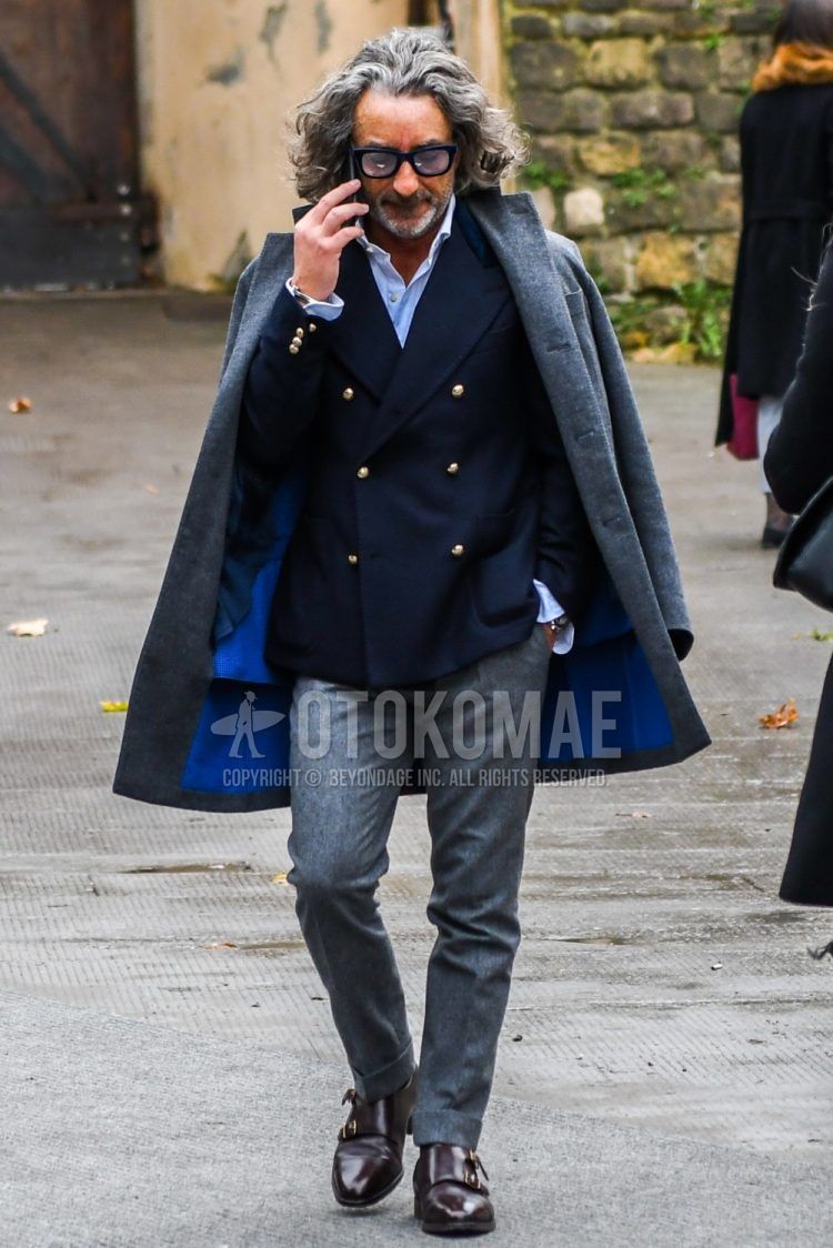 Men's fall/winter coordinate outfit with plain glasses, plain gray chester coat, plain navy tailored jacket, plain white shirt, plain gray slacks, and brown monk shoe leather shoes.