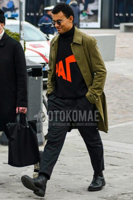 Fall and winter men's outfit with plain silver sunglasses, plain olive green stainless steel collar coat, plain black turtleneck knit by Gosha Rabchinsky, plain gray pleated pants, plain gray wool pants, and black country boots.