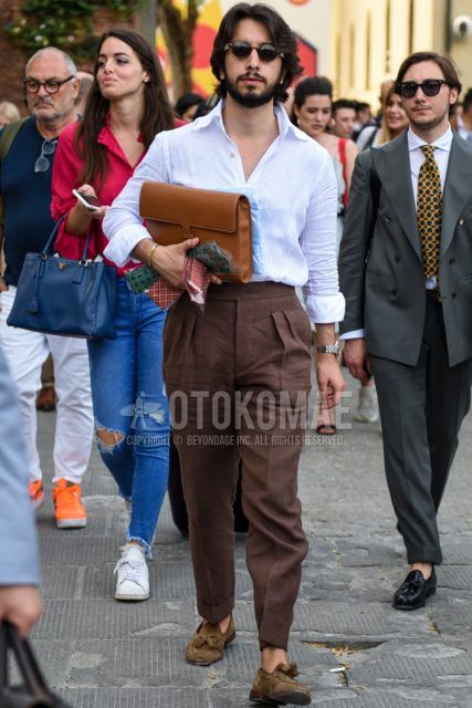 Men's spring/summer outfit with brown tortoiseshell sunglasses in Boston, plain white linen shirt, plain brown beltless pants, plain pleated pants, suede beige tassel loafer leather shoes, and plain brown clutch/second bag/drawstring bag.