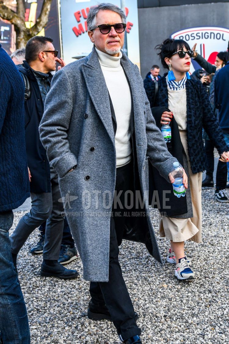 A plain sunglasses, plain gray chester coat, plain white turtleneck knit, plain gray tailored jacket, and plain black denim/jeans are worn together in this men's fall/winter outfit.