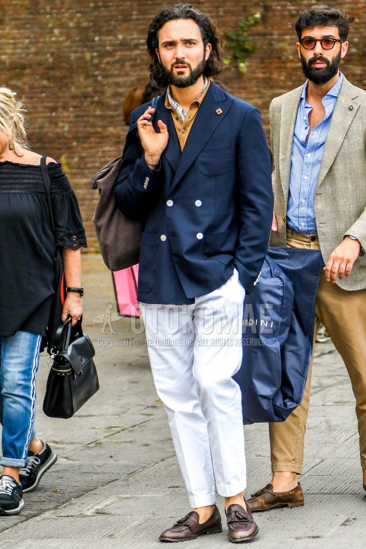 Spring and fall men's coordinate outfit with multi-colored other bandana/neckerchief, plain navy tailored jacket, plain beige shirt, plain white cotton pants, and brown tassel loafer leather shoes.