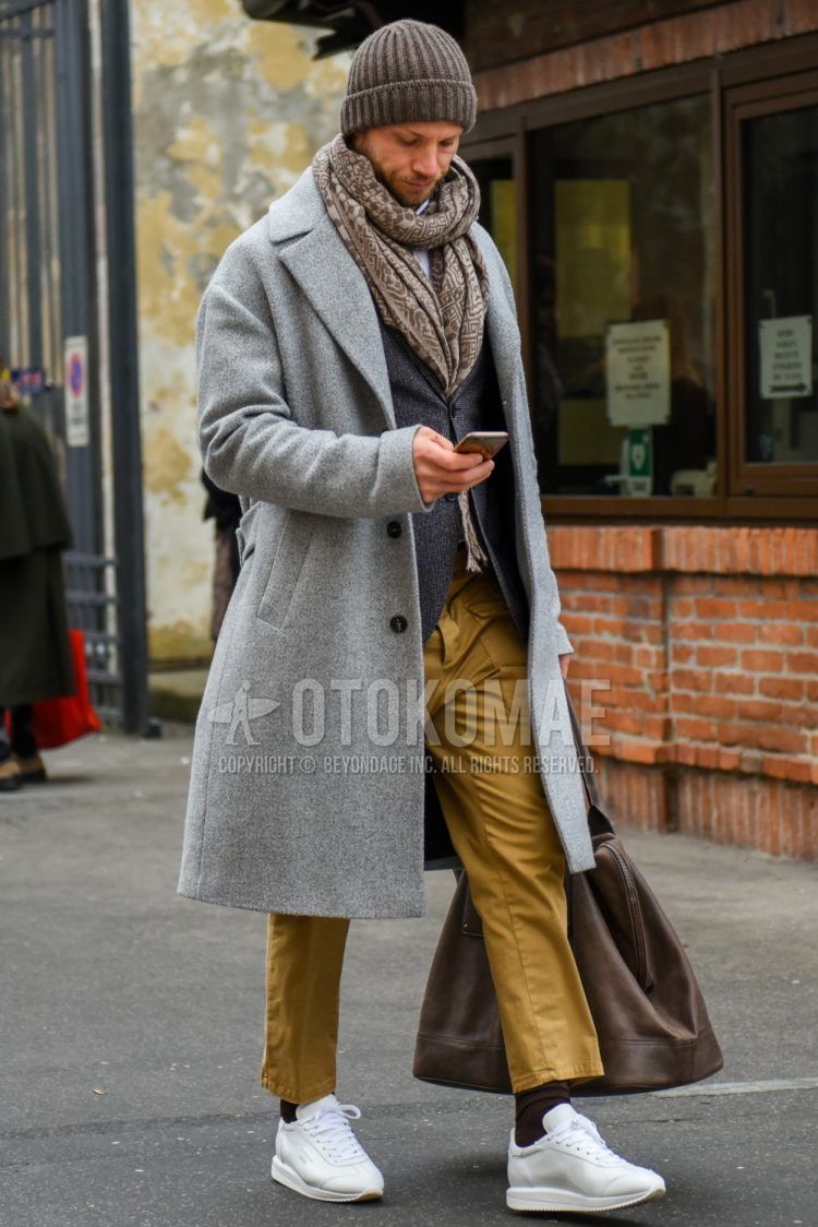 Olive green solid knit cap, beige solid scarf/stall, gray solid chester coat, gray/black other tailored jacket, beige solid chinos, solid cargo pants, brown/black border socks, white low cut sneakers, brown solid briefcase/handbag, and a winter men's outfit with a briefcase/handbag.