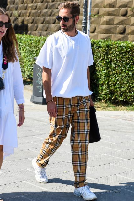 A summer men's oversized coordinate outfit with plain black sunglasses, a plain white t-shirt, beige checks, and white low-cut sneakers.