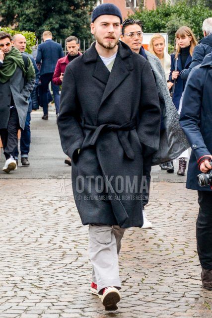 Winter oversized men's coordinate outfit with plain navy knit cap, plain black belted coat, plain white t-shirt, plain white wide pants, and red high-cut sneakers.