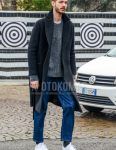 Fall/winter men's coordinate outfit with plain black chester coat, plain gray sweater, plain blue denim/jeans, plain gray socks, and white low-cut sneakers.