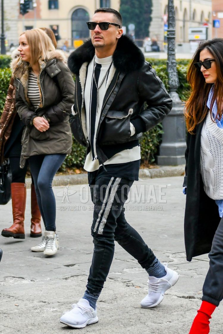 Winter men's coordinate outfit with plain sunglasses, plain black leather jacket (not riders), white striped sweater, plain black cotton pants, plain gray socks, and white low-cut sneakers.
