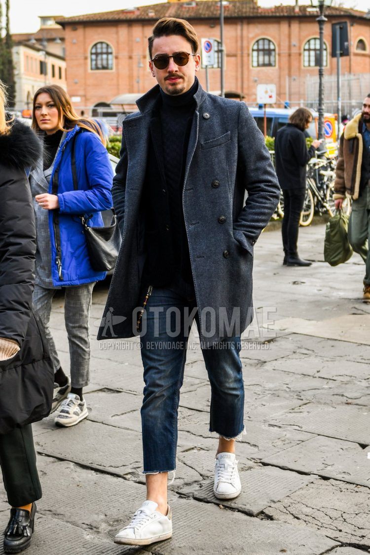 A men's fall/winter coordinate outfit with plain sunglasses, plain gray chester coat, plain black turtleneck knit, plain black denim/jeans, and white low-cut sneakers from Asics.