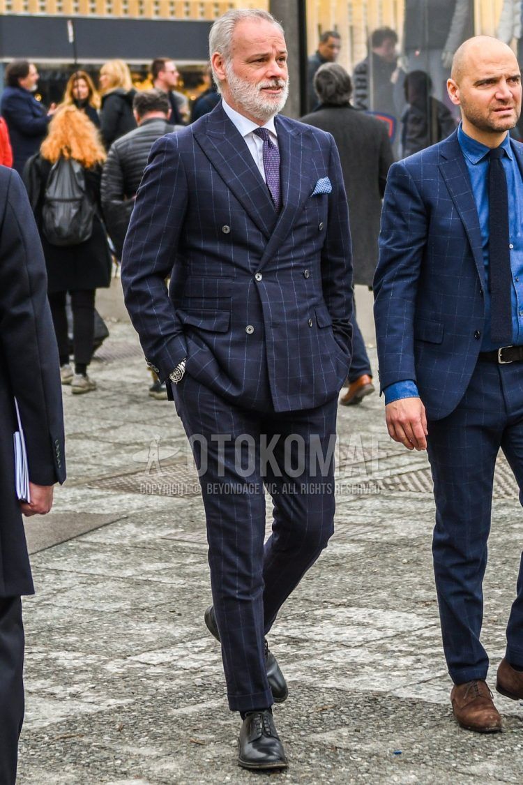 Winter men's coordinate outfit with plain white shirt, black plain toe leather shoes, navy check suit, and solid purple knit tie.