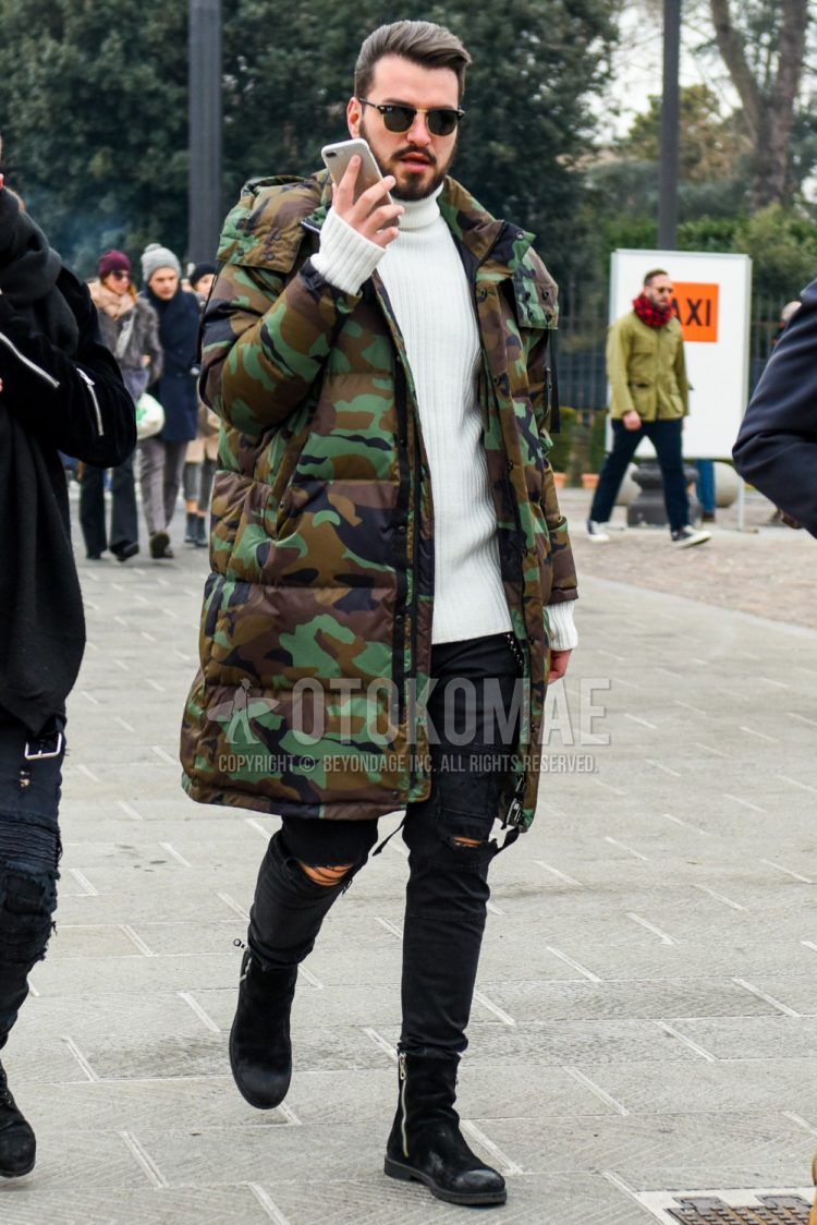 Men's coordinate and outfit with plain sunglasses, multi-colored camouflage hooded coat, plain white sweater, plain black damaged jeans, and black boots.