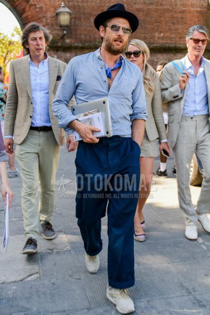 Men's coordinate and outfit with plain black hat, plain silver/black sunglasses, blue stole bandana/neckerchief, plain gray shirt with band collar, plain navy chinos, and beige low-cut sneakers.