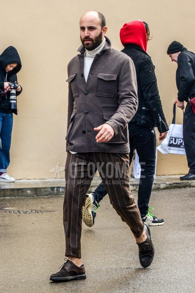 Men's coordinate and outfit with plain gray shirt jacket, plain white turtleneck knit, brown striped slacks, brown plain toe leather shoes, and suede leather shoes.