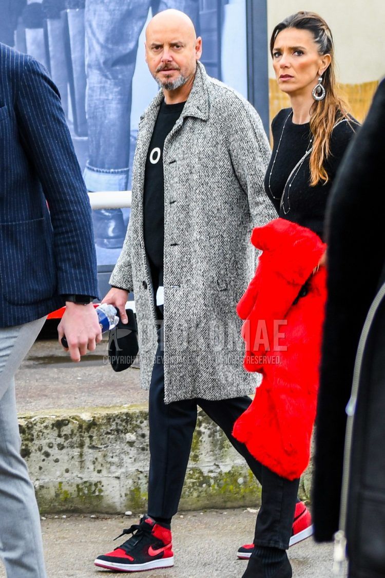Winter men's coordinate outfit with plain gray stainless steel coat, plain black sweater, plain black slacks, plain black socks, and Nike Jordan 1 red/black high-cut sneakers.
