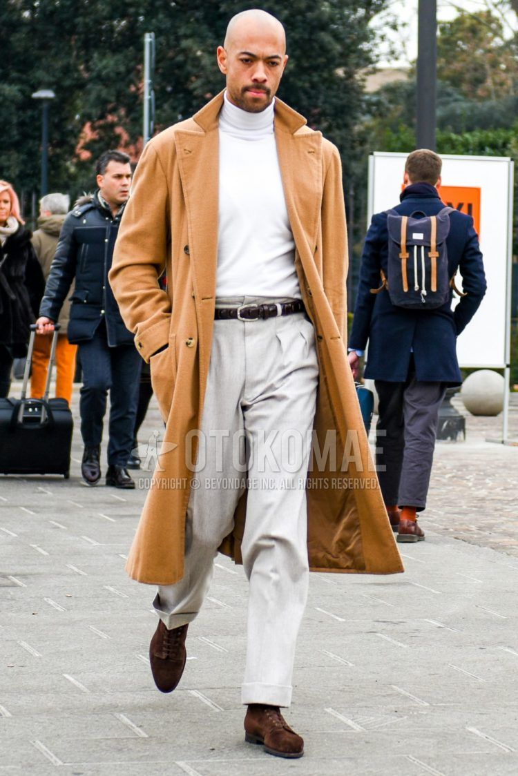 Fall and winter men's outfit with plain beige chester coat, plain white turtleneck knit, plain brown leather belt, plain mesh belt, plain gray slacks, plain gray pleated pants, and suede brown other boots.