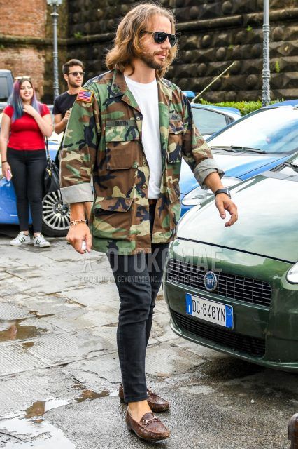 Men's coordinate and outfit with plain black sunglasses, olive green/brown camouflage M-65, plain white t-shirt, plain brown leather belt, plain dark gray denim/jeans, and brown bit loafer leather shoes.