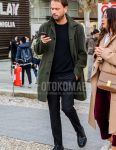 Fall and winter men's outfit with a plain olive green stainless steel collar coat, plain black sweater, plain gray slacks, and black plain toe leather shoes.