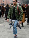 A men's fall/spring outfit with solid color sunglasses, solid color green MA-1, solid color black sweater, solid color white t-shirt, off-white solid color gray tape belt, solid color light blue denim/jeans, and Adidas Easy Boost 350 gray low-cut sneakers.