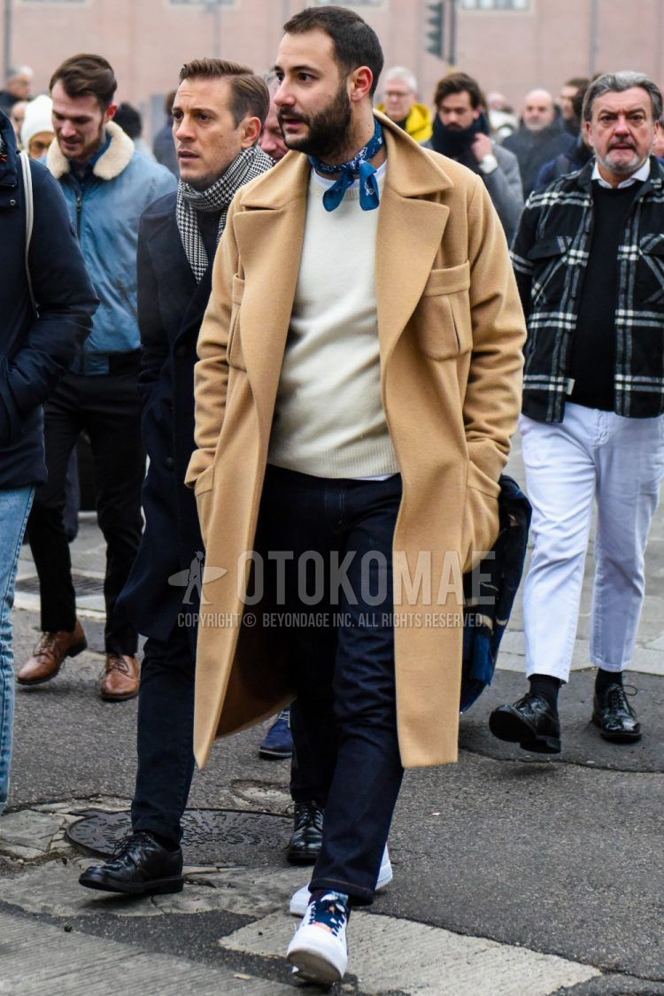 Men's coordinate and outfit with plain blue bandana/neckerchief, plain brown outerwear, plain white sweater, plain navy denim/jeans, and white low-cut sneakers.