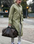 Men's coordinate and outfit with olive green solid color stainless steel collar coat, beige solid color cotton pants, white solid color socks, brown coin loafer leather shoes, and Louis Vuitton brown bag Boston bag.