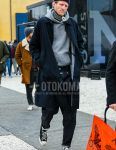 Solid navy knit cap, JW Anderson black and white striped snood, solid navy stainless steel collar coat, solid gray hoodie, solid navy denim/jeans, solid white socks, and Converse Chuck Taylor black low-cut sneakers for men in winter. Outfit.