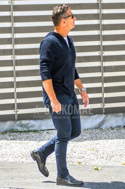 Men's coordinate and outfit with plain sunglasses, plain navy hoodie, plain white t-shirt, plain navy cotton pants, navy striped socks, and black coin loafer leather shoes.