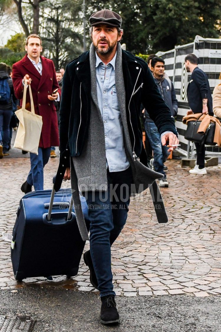 Solid color other, solid color gray scarf/stall, solid color black rider's jacket, solid color light blue denim/chambray shirt, solid color navy denim/jeans, brown chukka boots, suede shoes leather shoes, solid color navy suitcase, men's fall/winter outfit with .