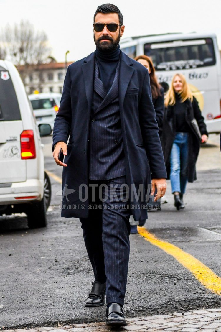 A plain black chester coat, plain black turtleneck knit, black monk shoe leather shoes, and a navy striped suit for men's fall/winter outfits.