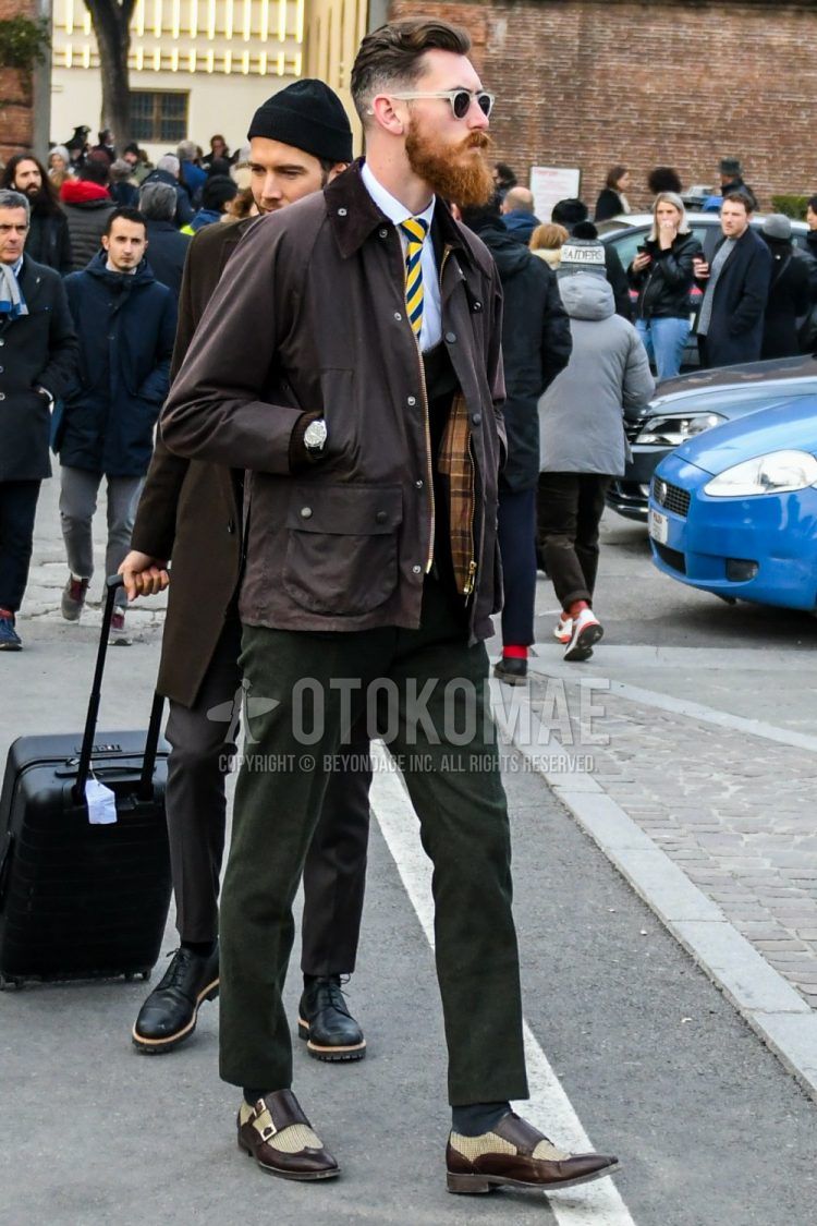 Plain sunglasses, plain brown field jacket/hunting jacket, plain white shirt, plain brown gilet, plain olive green slacks, plain gray socks, brown monk shoes leather shoes, yellow blue regimental tie, winter/fall/spring Men's Corded Outfits.