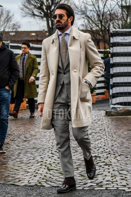 A winter men's outfit with plain sunglasses, plain white stainless steel coat, plain white shirt, brown other boots, black/gray checked suit, and plain brown tie.