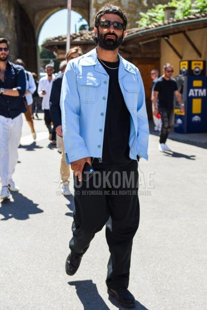 A men's fall/spring outfit with solid black sunglasses, solid light blue denim jacket, solid black t-shirt, solid black cotton pants, and black U-tip leather shoes.