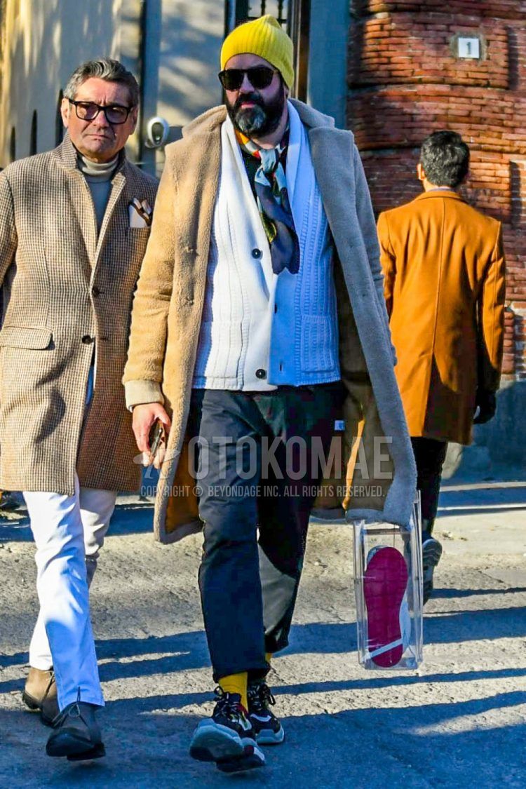 Solid yellow knit cap, solid sunglasses, multicolor solid scarf/stall, solid beige chester coat, solid white cardigan, solid black cotton pants, solid yellow socks, multicolor low cut sneakers, clear solid tote bag. Men's Codes and Outfits.