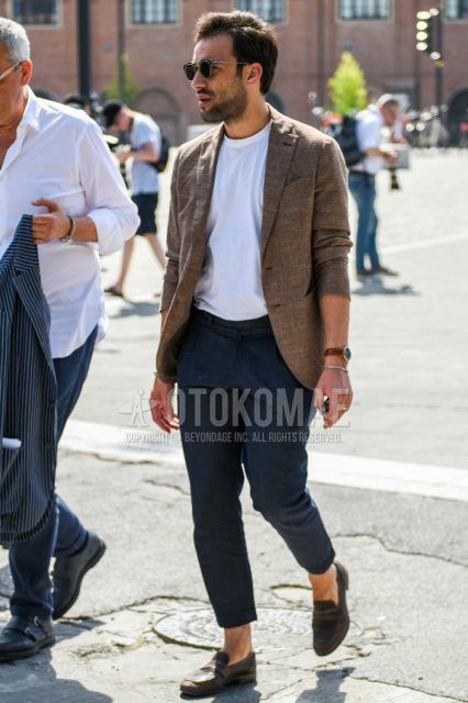 Men's coordinate and outfit with clear plain sunglasses, brown plain tailored jacket, white plain t-shirt, wool dark gray plain bottoms, and brown coin loafer leather shoes.
