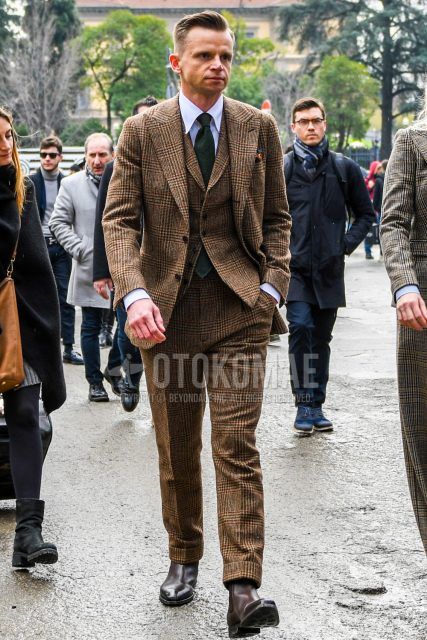 Men's fall/spring outfit with plain white shirt, brown side gore boots, brown checked three-piece suit, and plain green tie.