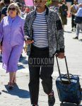 Men's coordinate and outfit with plain beige sunglasses, black and white outer MA-1, white striped t-shirt, dark gray plain slacks, black dotted socks, black coin loafer leather shoes, and black and blue bag suitcase.
