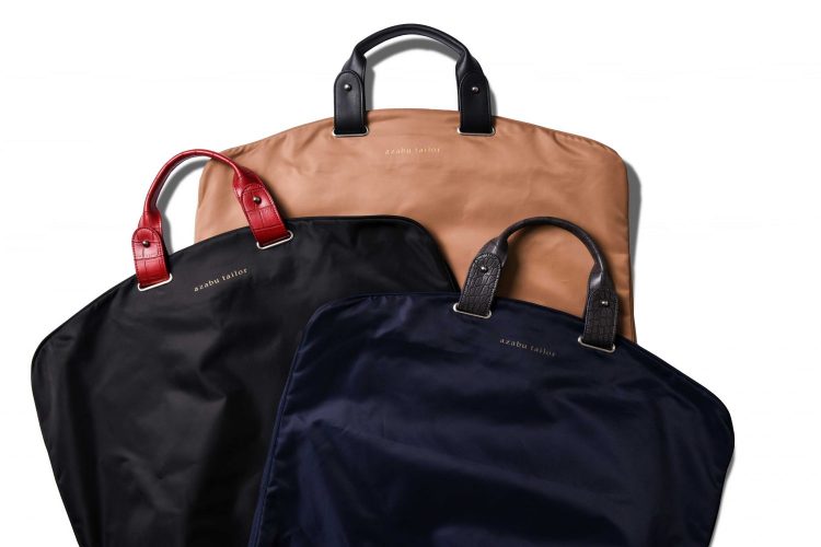Unlikely! Azabu Tailor Customized Garment Bags" with light poly body and sophisticated leather handles that can be customized to your liking.
