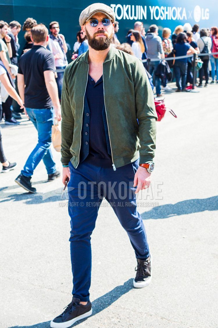 Other solid color, olive green solid color MA-1, plain navy t-shirt with henley neck, plain navy gilet, plain navy chinos, and black low-cut sneakers for men's fall and winter outfits.
