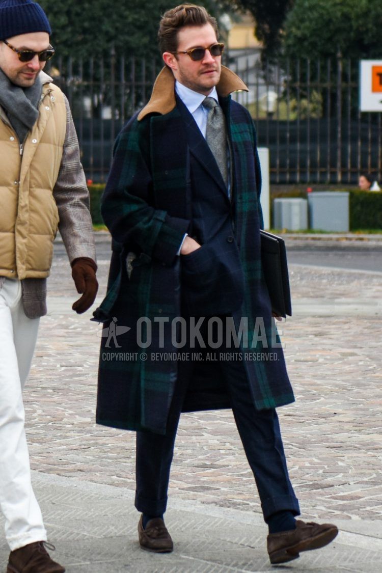Solid brown sunglasses, green checked Ulster coat, solid white shirt, solid navy socks, suede brown tassel loafer leather shoes, solid black clutch/second bag/drawstring, navy checked suit, gray checked tie. Men's Codes and Outfits.