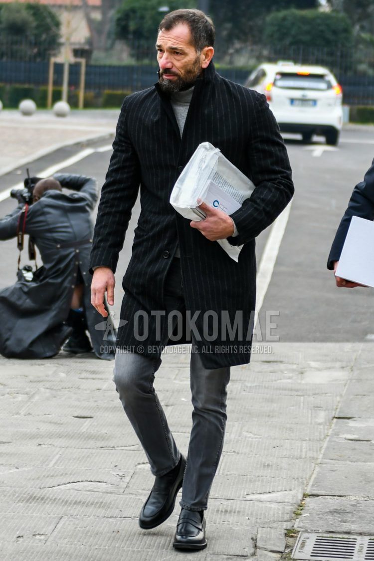 Men's coordinate and outfit with black striped chester coat, plain gray turtleneck knit, plain gray denim/jeans, and black coin loafer leather shoes.