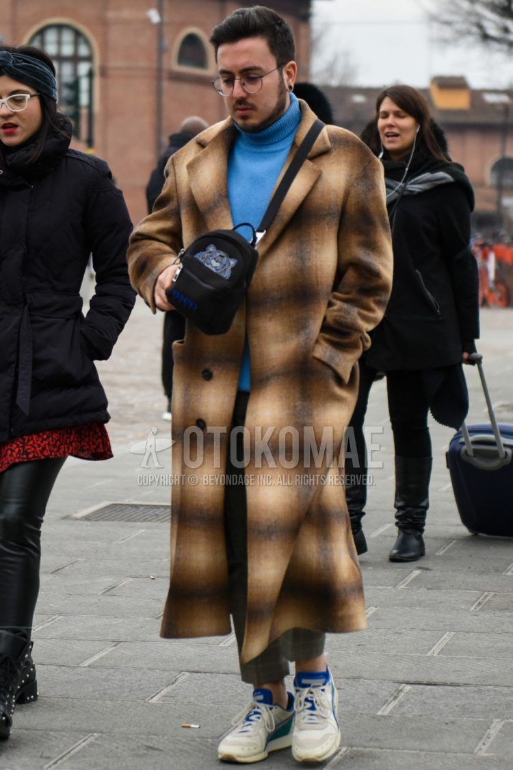 Men's coordinate and outfit with plain glasses, brown check chester coat, plain light blue turtleneck knit, white low-cut sneakers, and solid black Kenzo shoulder bag.