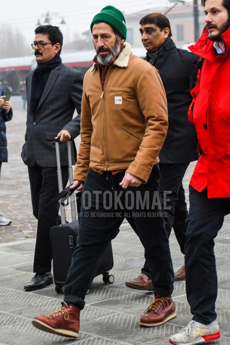 Men's coordination and outfit with plain green knit cap, plain brown outerwear, plain black cotton pants, and Red Wing brown work boots.