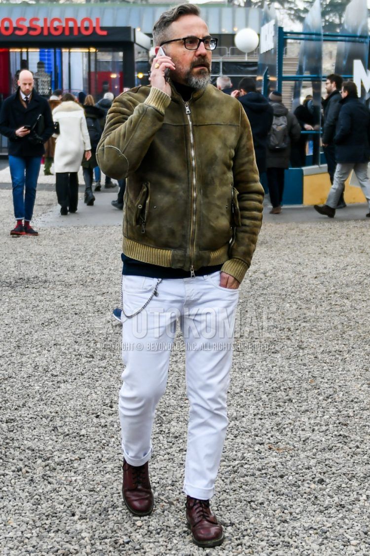 Men's coordinate and outfit with plain glasses, olive green plain leather jacket (except rider's), plain black turtleneck knit, plain white denim/jeans, and brown boots.