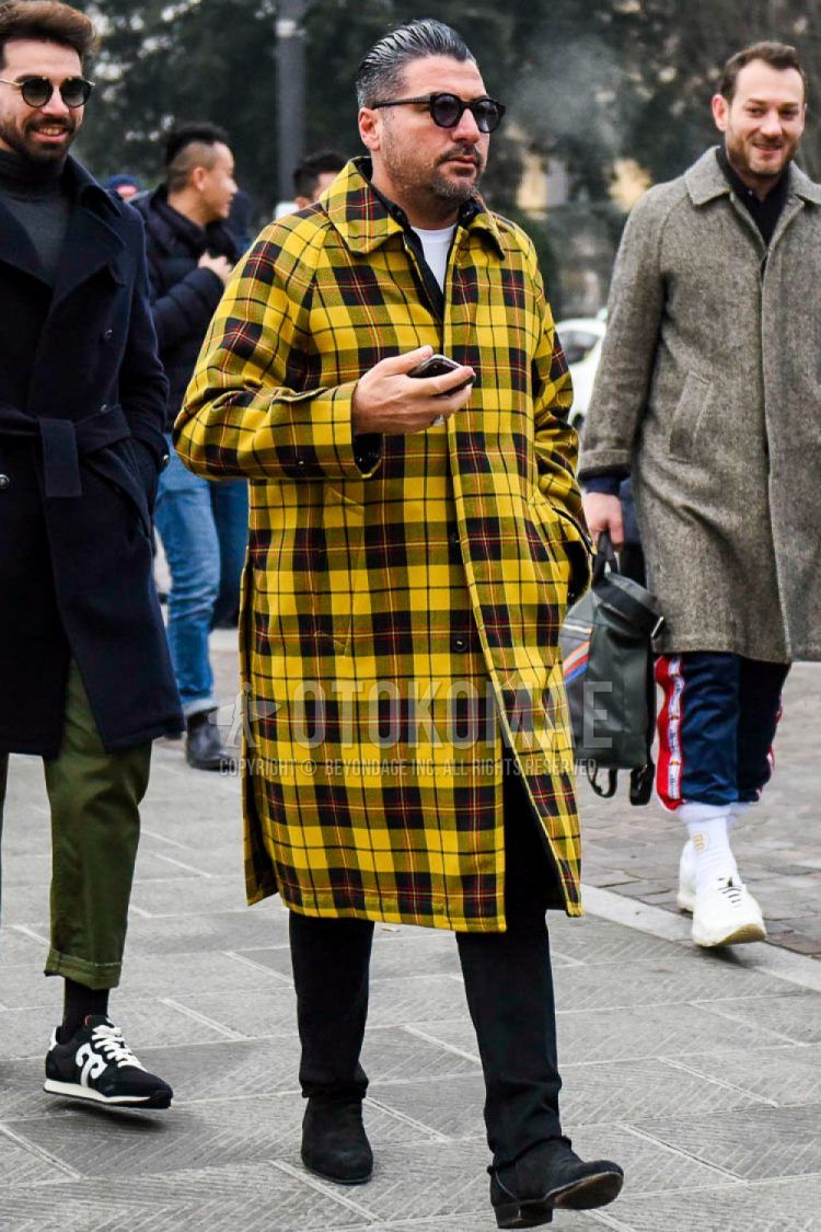 Men's coordinate and outfit with plain sunglasses, yellow checked stainless steel coat, plain white t-shirt, plain black cotton pants, and black boots.