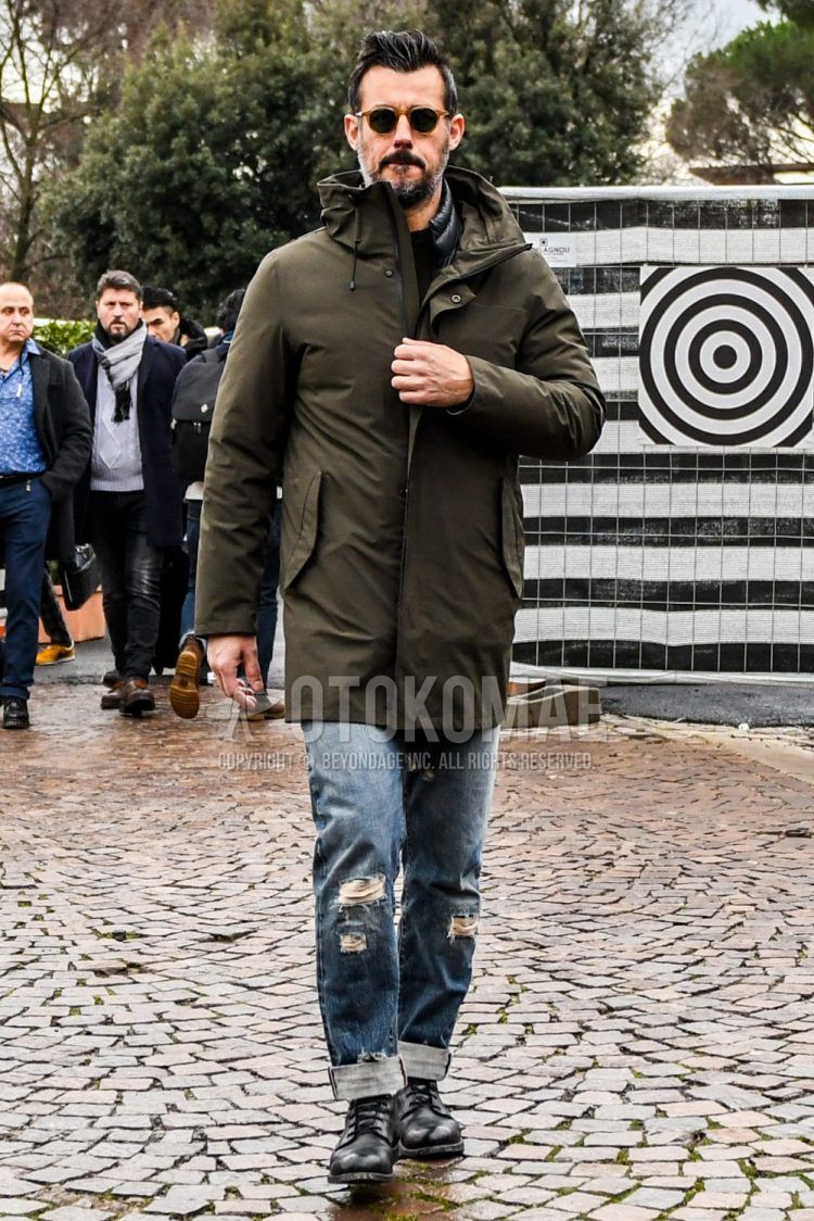 Men's coordinate and outfit with plain sunglasses, plain olive green down jacket, plain black inner down, plain black t-shirt, plain blue damaged jeans, and black boots.