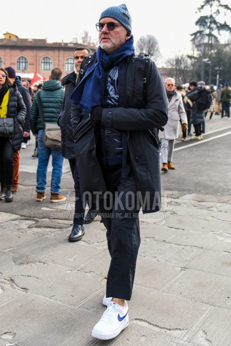 Men's coordinate and outfit with solid gray knit cap, solid sunglasses, solid blue scarf/stall, solid black hooded coat, solid black cotton pants, and Nike Air Force 1 white low-cut sneakers.