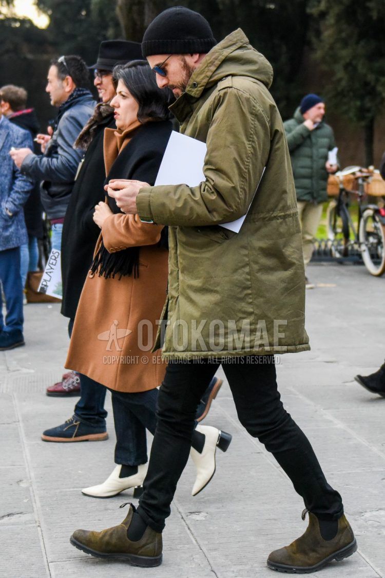 Men's coordinate and outfit with solid black knit cap, solid sunglasses, solid beige down jacket, solid black denim/jeans, and beige side gore boots.