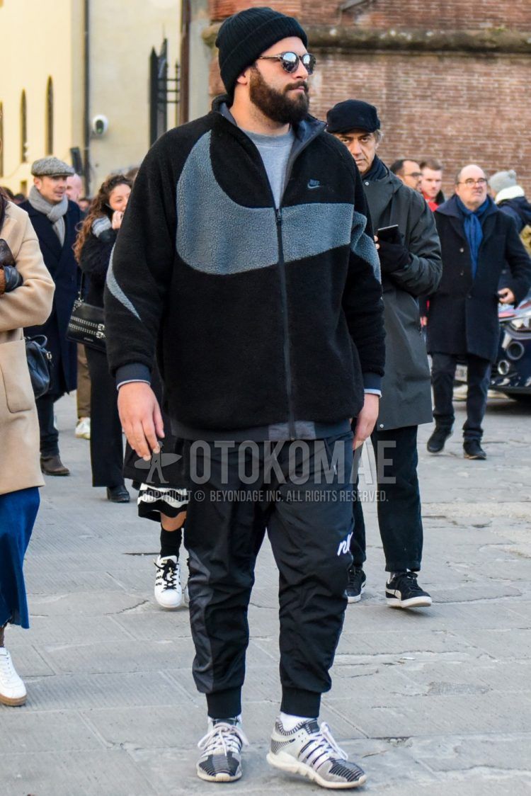 Men's coordinate and outfit with plain black knit cap, plain sunglasses, plain black fleece jacket, plain gray sweater, plain black jogger pants/ribbed pants by Nike, plain white socks, and white low-cut sneakers by Adidas.