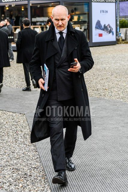 Men's coordination and outfit with plain black trench coat, plain white shirt, black plain toe leather shoes, plain gray suit, and plain black tie.