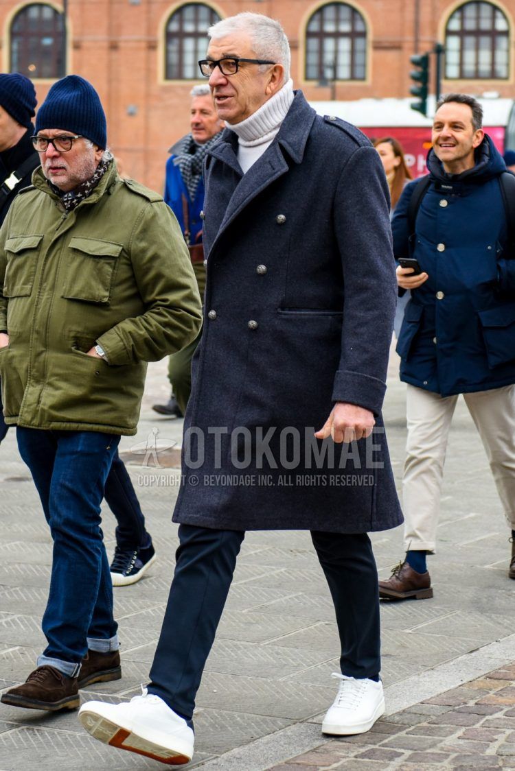 Winter men's coordinate and outfit with plain black glasses, plain navy Ulster coat, plain white turtleneck knit, plain navy slacks, and white low-cut sneakers.