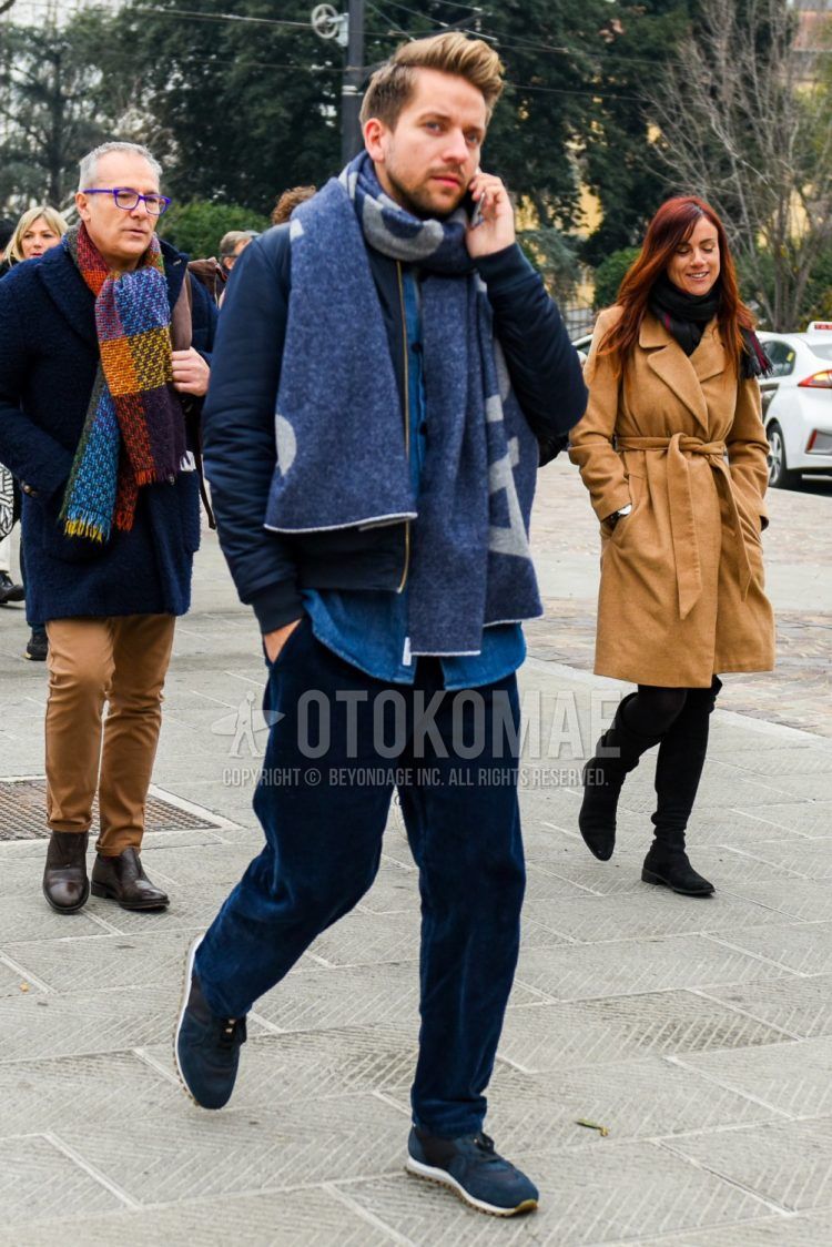 Men's coordinate and outfit with navy graphic scarf/stall, plain navy MA-1, plain navy denim/chambray shirt, plain navy winter pants (corduroy, velour), navy low-cut sneakers.